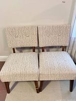 Front view of both chairs showing fabric, design and leg style