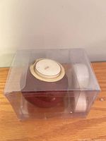 red glass candle holder with candle inside, packaged