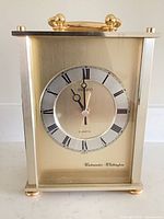 Front view of Seiko brass mantel clock showing dial and case