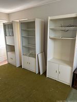 Three white bookcases side by side showing overall design and size