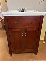 Front view of vanity showing sink, faucet, drawer front, cabinet doors