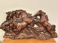 Front view of entire carved wooden horses plaque