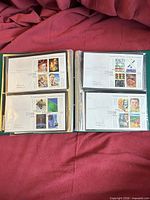 Album page with four sleeved first day covers visible