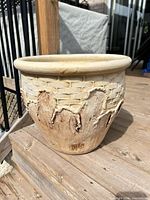 Full view of ceramic planter on deck