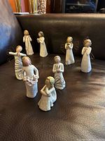 Group shot of all eight Willow Tree angel figurines on sofa