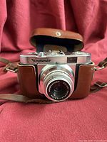 Front view of Voigtländer Vito B camera in leather case showing lens and strap