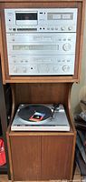 Front view of full stereo cabinet showing all components and turntable