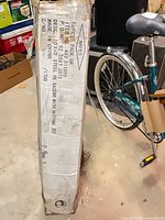 Tall shipping box showing printed description 10'x10' steel PE gazebo w/ netting