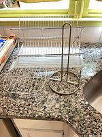 Full view of rack, drip tray, paper towel holder and wire trivet on counter