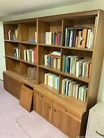 Front view of both modular bookcases showing shelves, cabinets, detached doors