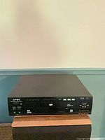Front view of Apex AD-151 DVD player showing disc tray, controls and logo