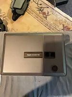 Top view of projector showing brand badge and focus knob