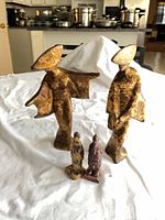 All four figurines grouped on tabletop