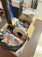 Box showing assorted cables and accessories