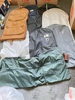 Overview of nine assorted garment bags laid out showing colors and materials