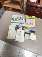 Overview of boxed and packaged stationery items on table