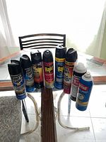All eight insecticide cans lined on table for overview