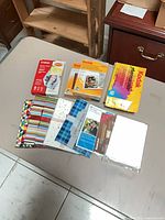 Overview of all photo paper boxes and cardstock packs on table
