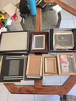 Group shot of all eight frames on glass table