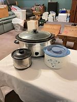 Three slow cookers in assorted sizes and finishes