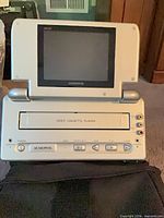 Audiovox portable VCP/VCR open, showing screen, cassette slot and front controls