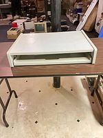 Closed beige plastic keyboard drawer housing
