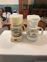 Both coffee makers side by side showing overall condition and included carafes