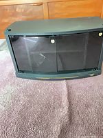 Front view of black MDF TV stand with closed glass doors
