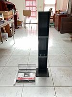 tower standing upright with loose wire shelf on floor