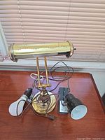All three lamps grouped on desk showing cords and bulbs