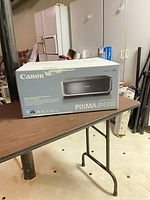 Boxed Canon PIXMA iP4300 printer on table
