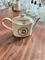 Oblong porcelain teapot showing dragon motif and overall form