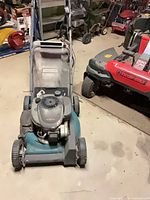 Front view of Centura Elite mower showing deck, engine, wheels, handle