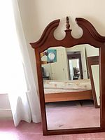 Front view of dresser mirror standing against wall