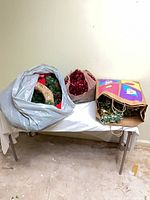 Bags containing wreaths and tinsel on table