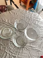 All four clear glass bakeware pieces on table