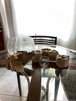 Overview showing punch bowl, two mugs, four wrapped items on table