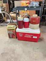 Group shot of cooler, three jugs and boxed zapper