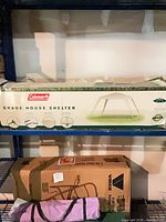 Retail box showing Coleman shade house shelter graphics and specifications