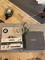 Recorder with cover removed, empty reel mounted, control panel visible