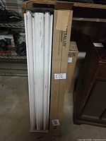 Entire fixture with tubes beside original Metalux box