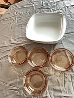 Group shot of four amber bowls and one white square baking dish