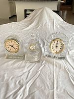 Group view of three crystal clocks showing overall forms and relative sizes