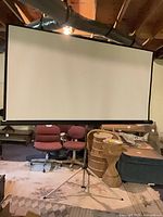 Front view of Da-Lite projection screen fully extended on tripod