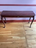 Full front view of mahogany console table showing overall design and finish