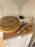 Overall lot with straw pillow, storage box, folding clock, rolled scroll, peg rack
