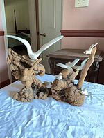 Both sculptures showing driftwood bases and painted seagulls