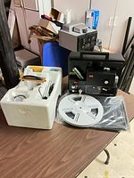 Projector, reel and styrofoam inserts on table