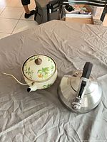 Both teapot and kettle side by side on table