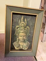 Front view of framed Asian deity relief